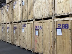 Two tiers of numbered wooden storage vaults with inventory sheets in the Perfect Storage warehouse