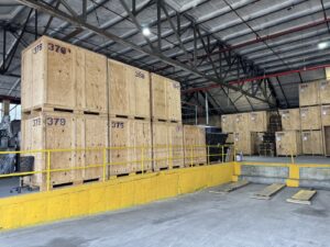 Numbered wooden storage vaults stacked by a loading dock in the Perfect Storage warehouse